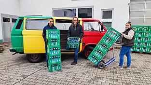 Andreas und Beate Kick zusammen mit ihrem Sohn Alois (links) im Hof des Familienbetriebs. Der bunte VW-Bus ist eines der Markenzeichen.