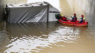 Einsatzkräfte der Wasserwacht in Saulgrub blicken Anfang Mai in einen Kleinlaster der überflutete Unterführung. Einsatzkräfte der Wasserwacht in Saulgrub blicken Anfang Mai in einen Kleinlaster der überflutete Unterführung.