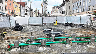 Acht der insgesamt neun Fontänentöpfe sind auf diesem Foto zu sehen. In den schwarzen Leitungen wird das Wasser zu den Düsen gepumpt, in den grünen Leitungen läuft es zurück zum Filter und Wasserspeicher.
