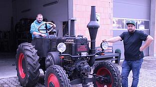 Die Freunde Sepp Pfeffer (l.) und René Raster an einem Paradestück, einem Lanz mit 25 PS, Baujahr 1939