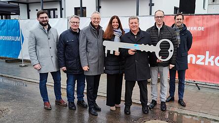 Die symbolische Schlüsselübergabe (v.l.): Alexander Hartl (stv. Geschäftsführer Penzkofer Bau), MdL Josef Zellmeier, OB Markus Pannermayr, Kristina Frank (Geschäftsführerin Baunova Bayern GmbH), Staatsminister Christian Bernreiter, MdL Martin Behringer und Fabian König (Geschäftsführer BayernHeim).