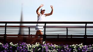 Iga Swiatek lässt sich von den Fans auf einer Brücke vom Centre Court in Wimbledon feiern.