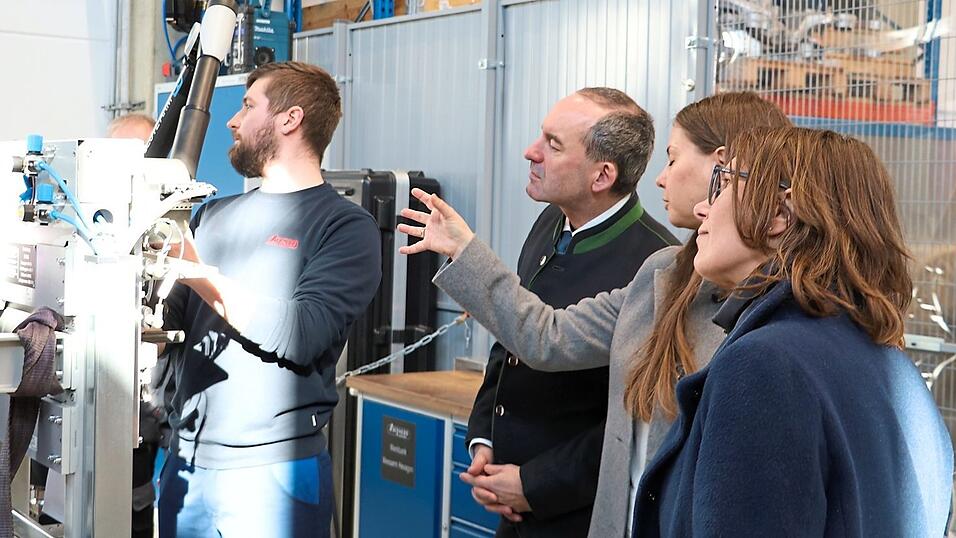Wirtschaftsminister Hubert Aiwanger (3. v. r.) l&auml;sst sich von Gesch&auml;ftsf&uuml;hrerin Carmen Schnupp (2. v. r.) die Maschinen im Werk erkl&auml;ren.