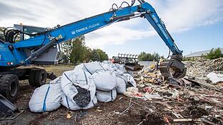 Ein Bagger häuft Müll auf. Eine deutsche Abfallfirma soll illegal Müll entsorgt haben, der nun vom Freistaat Bayern zurückgeholt werden muss.
