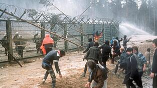 Demonstranten protestieren am Bauzaun gegen den Bau der Wiederaufarbeitungsanlage (WAA).