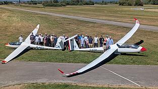 Die Teilnehmer und Trainer stellen sich zum Gruppenfoto mit den beiden Verbandsflugzeugen „LS8“ und „Arcus T“ auf. Die Teilnehmer und Trainer stellen sich zum Gruppenfoto mit den beiden Verbandsflugzeugen „LS8“ und „Arcus T“ auf.