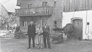 Das alte Würzinger-Haus in Zeholfing war in den 40er-Jahren außen noch mit Holz verkleidet. An der Traufseite, unterhalb der Dachrinne, hängen keine Stoffstücke oder Unterhosen zum Trocknen. Es sind Tabakblätter, die der alte Würzinger für den Eigenbedarf trocknete. Er steht mit Frau und Sohn Josef im Bildvordergrund.