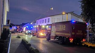 Feuerwehrfahrzeuge stehen vor dem Supermarkt.