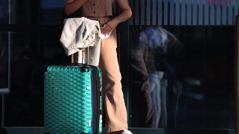 Ein Fluggast steht vor einem Terminal. Ein Fluggast steht vor einem Terminal.