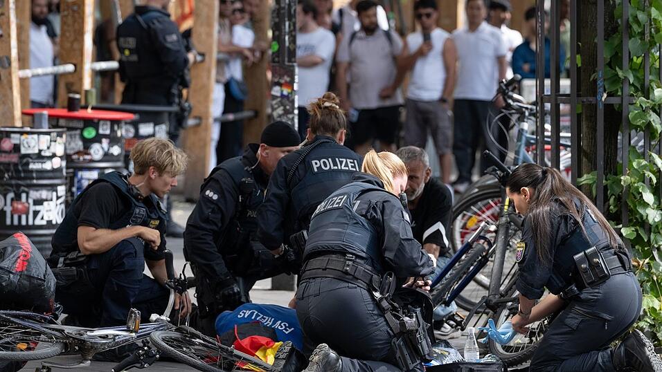 Polizisten knien in der Nähe des Frankfurter Hauptbahnhofs am Boden und kümmern sich um einen Verletzten. Polizisten knien in der Nähe des Frankfurter Hauptbahnhofs am Boden und kümmern sich um einen Verletzten.