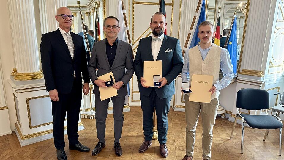 Helmut Eckl, Alexander Kracun und Xaver Steger mit Regierungspr&auml;sident Walter Jonas. Sie retteten einen stark unterk&uuml;hlten Mann aus dem Wei&szlig;en Regen und bekamen daf&uuml;r eine Medaille.
