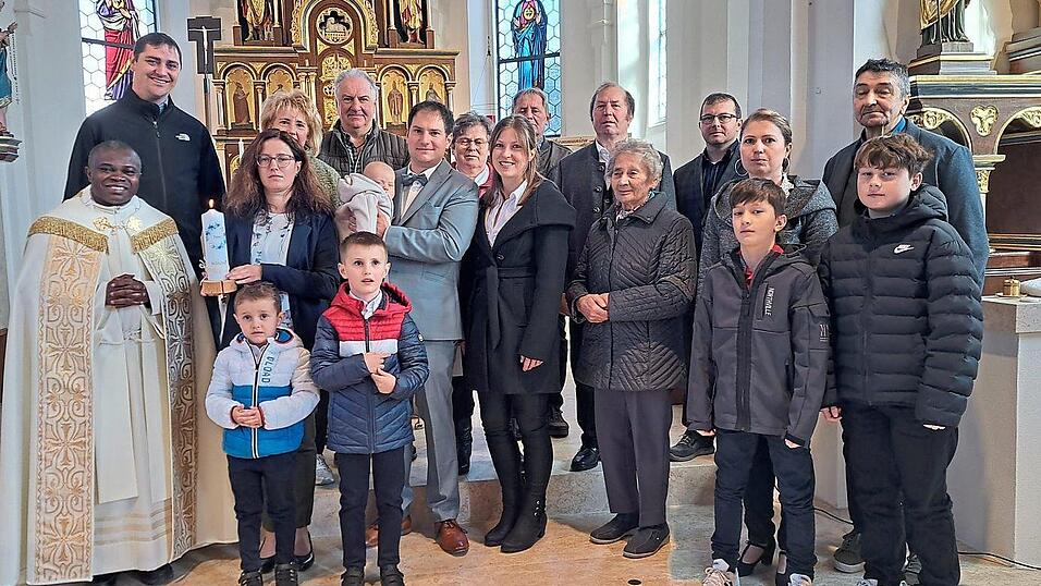 Die Tauffamilie Eckl im Altarraum der Zandter Marienkirche mit Vikar Matthias Tang.